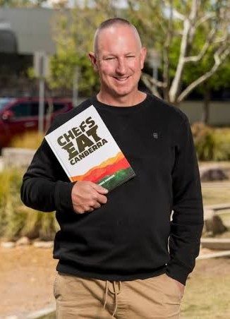 Chris Hansen holding Chefs Eat Canberra