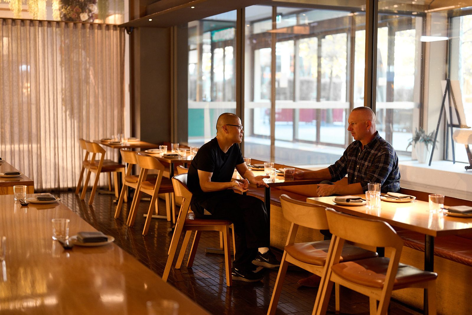 Chris Hansen discussing restaurant service with Hao Chen from Raku